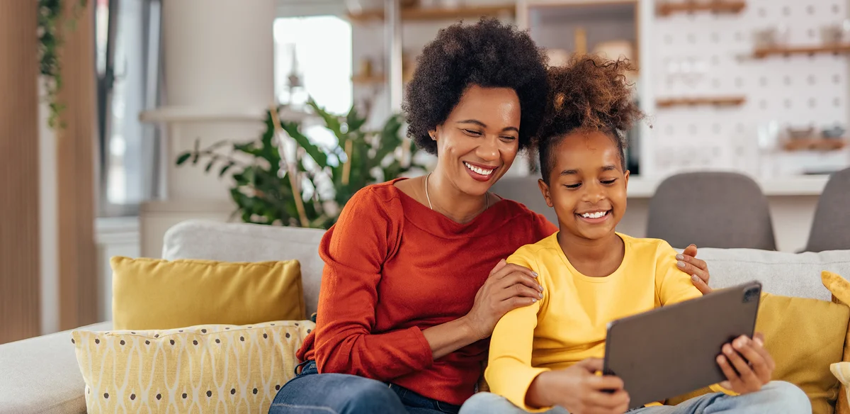 Mother and daughter using their tablet