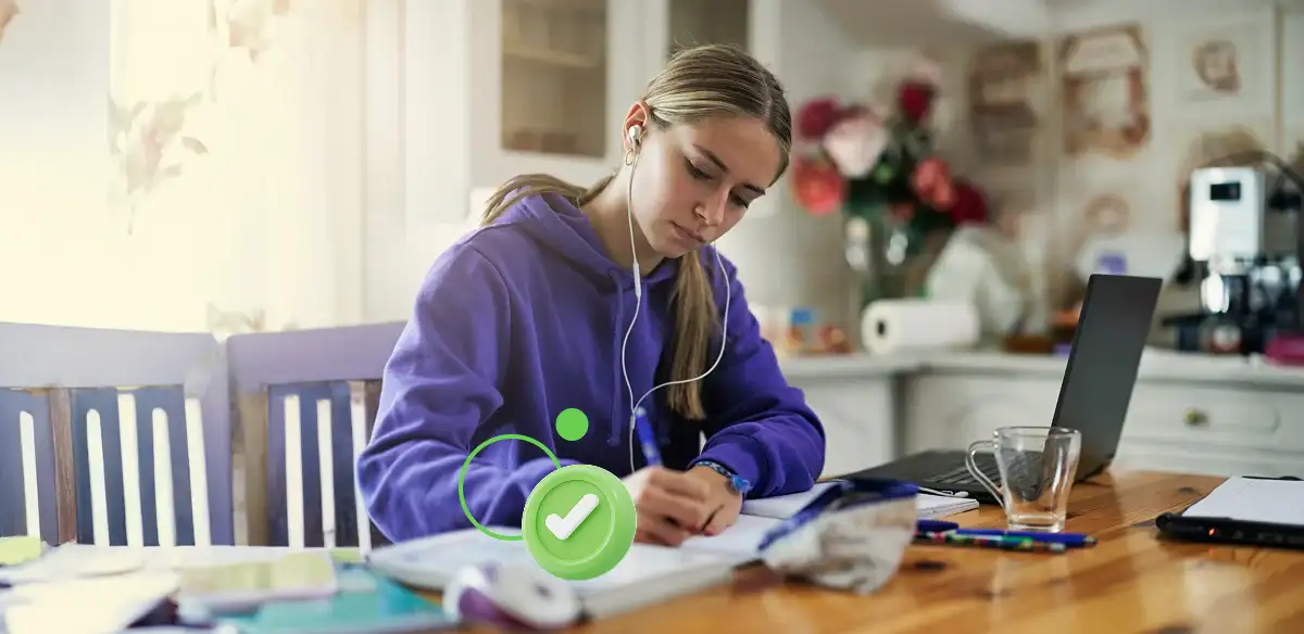 Student taking notes at home